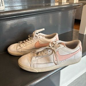 Nike white sneakers with pink swoosh